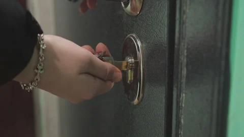 Intimate moment captured as key turns in lock. Detailed shot of fingers rotating Stock Footage 342339324