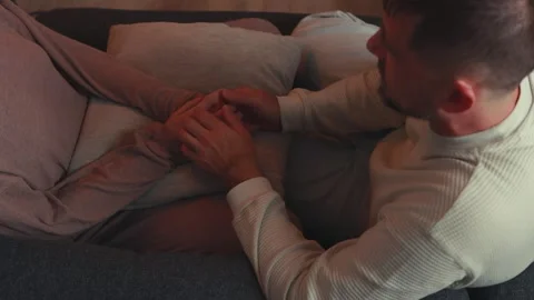 Intimate partners tenderly touching, cuddling close on living room sofa, sh.. Stock Footage 304077329