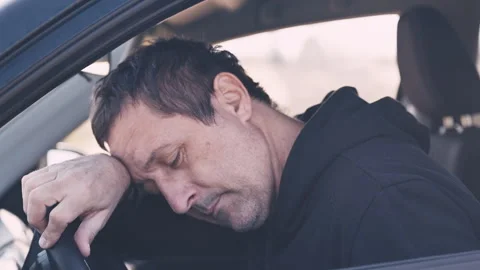 Intimate portrait of a middle-aged man, seated in driver's seat of a car. H.. Stock Footage 341662086