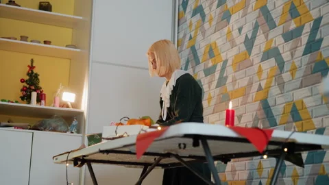 Intimate scene of woman preparing festive packages in warm environment. Creative Stock Footage 333321553