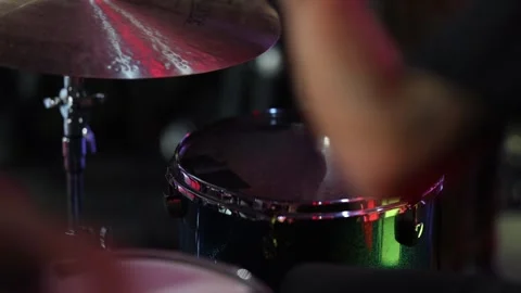 Intimate shot capturing rhythmic drumming with dazzling reflections Stock Footage 323946392