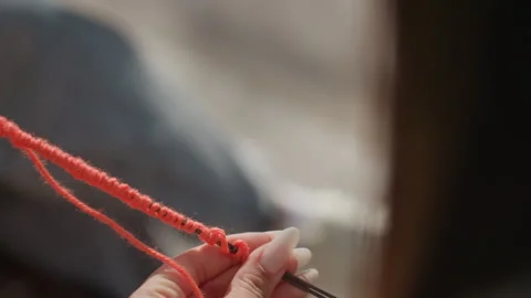 Intimate view capturing gentle knitting process with warm ambiance, an upclose Stock Footage 323319665