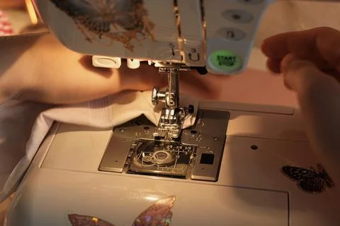 Intimate View of Talented Hands Operating a Sewing Machine Stock Photos