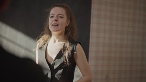 Intimate vocal coaching session with instructor. Expressive female student Stock Footage 346558473