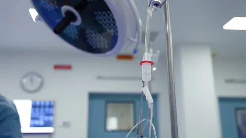 Intravenous drip in focus connected to the bottle of medicines. Stock Footage 286042243