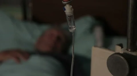 Intravenous drip. Patient lying on bed in hospital room and receiving infusion. Stock Footage