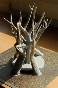 Intricate 3D printed tree stands tall with support structures on the plate 库存照片