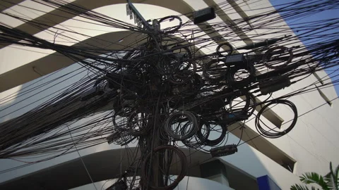 An intricate cable network runs above rooftops, showcasing the complexity Stock Footage 319908654