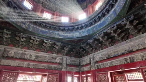 Intricate dragon caisson ceiling and red latticework doors with sunlight stre Stock Footage 331594979