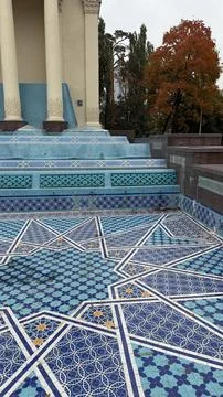 Intricate geometric blue tile patterns with autumn trees in background Stock Photos