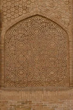 Intricate geometric brickwork panel with turquoise tile accents on a histor.. Stock Photos