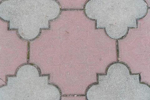 Intricate Geometric Pattern of Paved Walkway Tiles in Soft Earthy Tones Stock Photos
