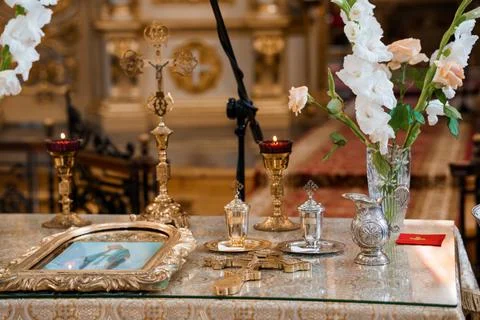 Intricate golden liturgical objects including chalices, crosses, and a framed Stock Photos