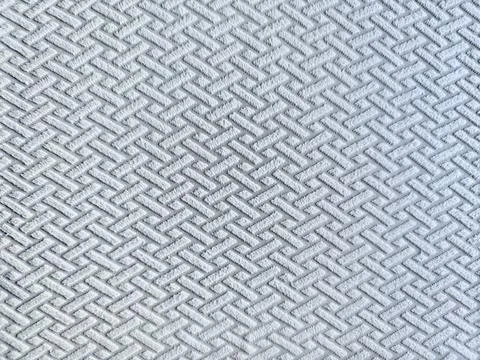 Intricate herringbone weave in soft light blue fabric texture captured in det Stock Photos