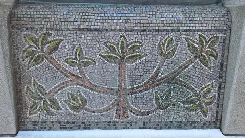 Intricate leaf patterned mosaic artwork on stone surface Stock Photos