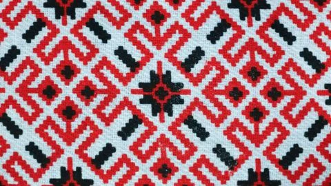 Intricate Mirukser textile pattern showcasing vibrant red and black designs.. Stock Photos