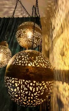 Intricate Moroccan Style Lanterns Casting Shadows On Textured Wall With Gre.. Stock Photos