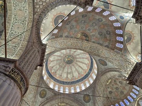 Intricate mosque dome interior with patterned arches and calligraphy Stock Photos