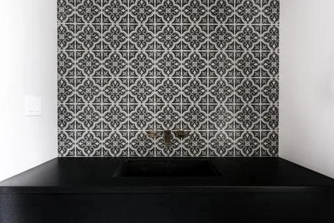 Intricate Patterned Black And White Tiles With A Sleek Black Countertop Sink. Stock Photos