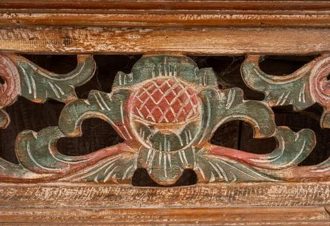 Intricate patterns and pineapple design in an old wooden door panel with muted Stock Photos