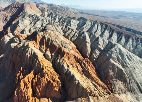Intricate patterns of red, orange, and gray eroded mountain slopes Stock Photos