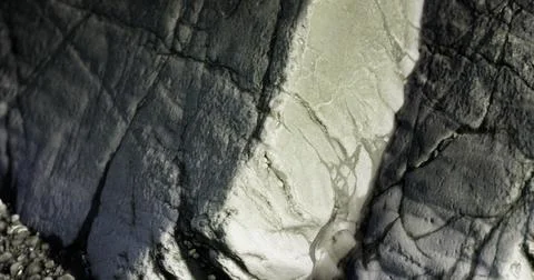 Intricate patterns on a rugged rock face illuminated by soft light Stock Illustration