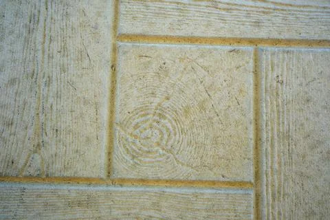 Intricate patterns of textured flooring in a sunlit area Stock Photos