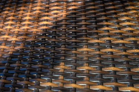 Intricate patterns of woven textures catch soft sunlight in an outdoor settin 스톡 사진