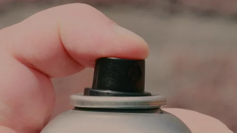 Intricate process of spraying paint with a can in close-up at an outdoor cr.. Stock Footage 310714366