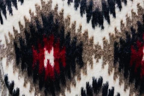 Intricate textile pattern with geometric shapes and a blend of colors. Stock Photos