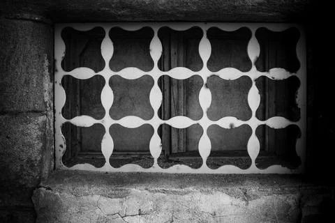 Intricate wall design with a patterned window in a historic building during Stock Photos
