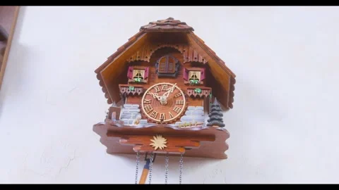 An intricately decorated cuckoo clock displaying traditional craftsmanship and 스톡 동영상 266958450