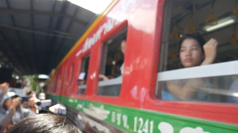 Intriguing experience, Train passing through the market in Thailand Stock Footage 116992744