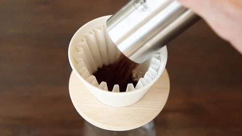Introducing Coffee Grounds to a Pour Over Dripper Stock Footage 103173001