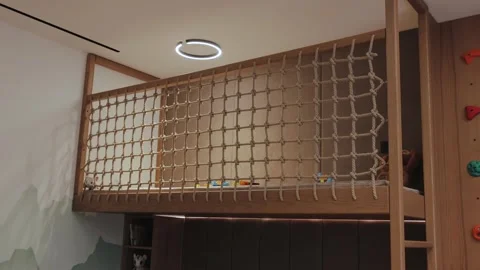 Introducing the Modern Kids Loft Bed with a climbing wall and safety net for Stock Footage 285437354