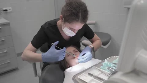 The introduction of infiltration anesthesia into the gum before tooth extraction Stock Footage 261996813