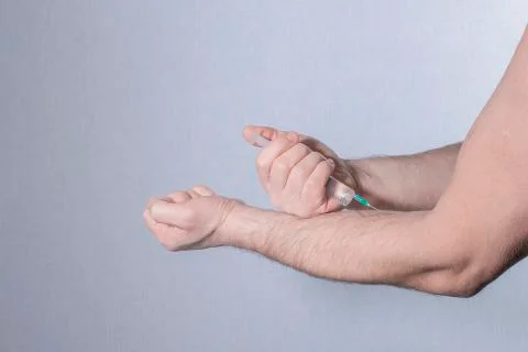 Introduction of injections into the arm Stock Photos
