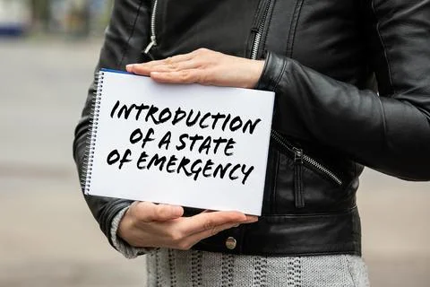 Introduction of a state of emergency. Notebook in a woman's hand Stock Photos