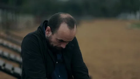 Introspective man stands alone, feeling hopeless and distant Stock Footage 313605761
