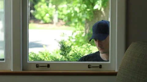 Intruder trying to enter window of home Stock Footage