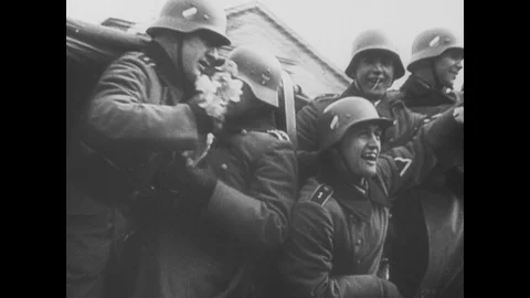 Invading German troops are greeted by cheering crowds Stock Footage 103376108
