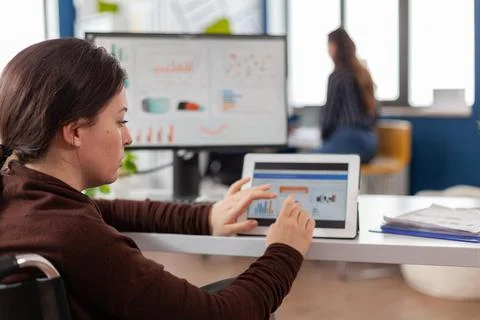 Invalid entrepreneur using pc and tablet in same time checking graphs Stock Photos