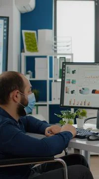 Invalid manager with face mask explaning to black employee financial evolution Stock Photos