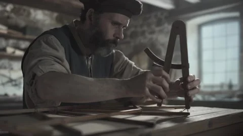 Inventor measuring ornithopter wing elements with a wooden compass, workshop Video stock 338991421