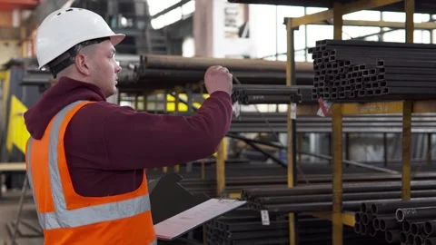 The inventory control inspector walks through the workshop and takes notes. Stock Footage 275895131