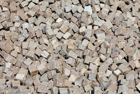 Inventory of cut small rectangular granite cobblestones ( setts ) 스톡 사진