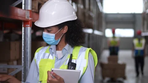 Inventory manager working on tablet in storehouse Stock Footage 161946186