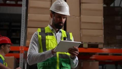 Inventory manager working on tablet in storehouse Stock Footage 161949848