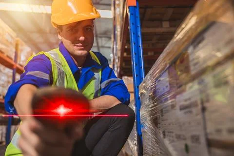 Inventory staff worker with handheld red laser barcode scanner label scan g.. Stock-Fotos