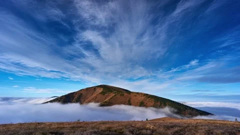 Inverse clouds moving around the top of a mountain in a national park. Stock Footage 165601532